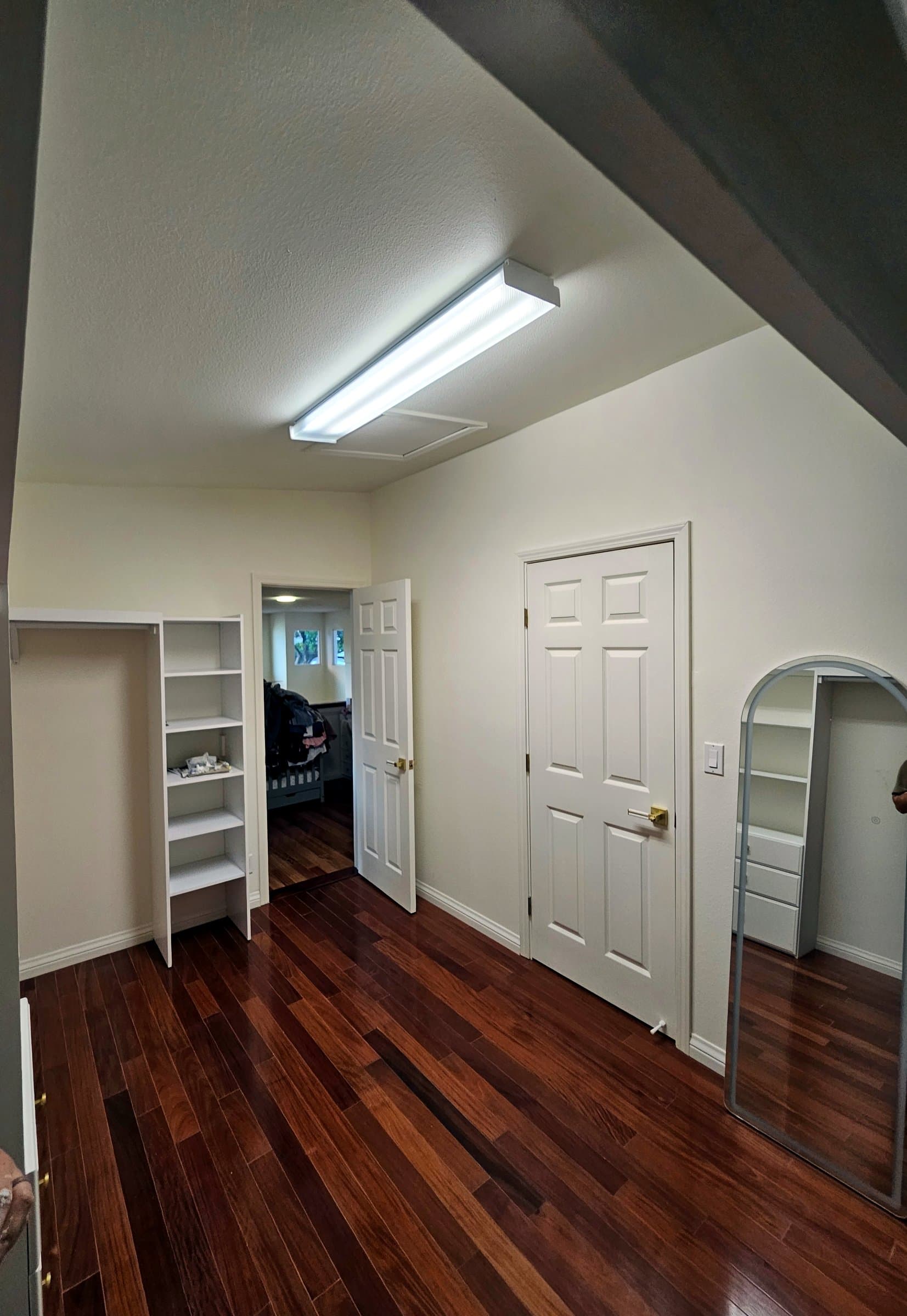 Freshly painted white room with a hardwood floor